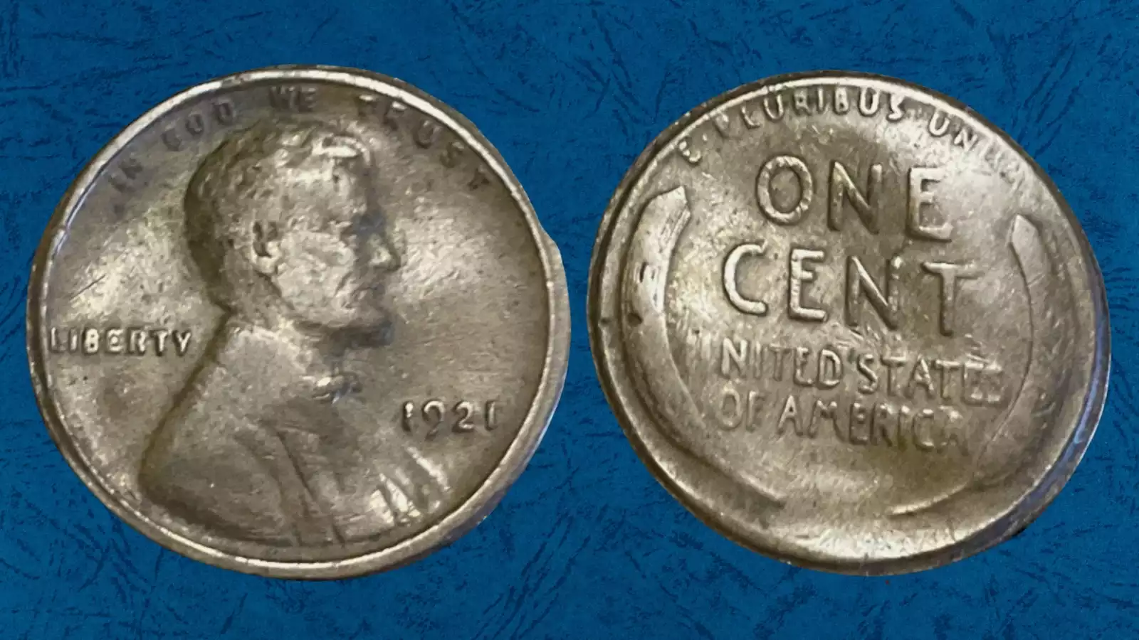 1921 wheat penny broadstrike error showing expanded diameter and missing rim compared to normal coin